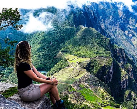 Tourist looking at the MahuPicchu Sanctuary | Ile Tours