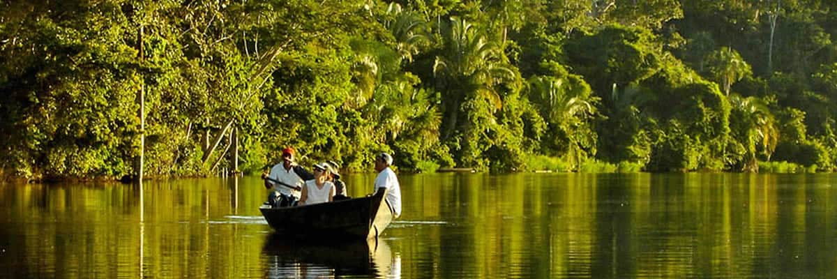 Tourists on boat touring the Amazon Reserve | Ile Tours