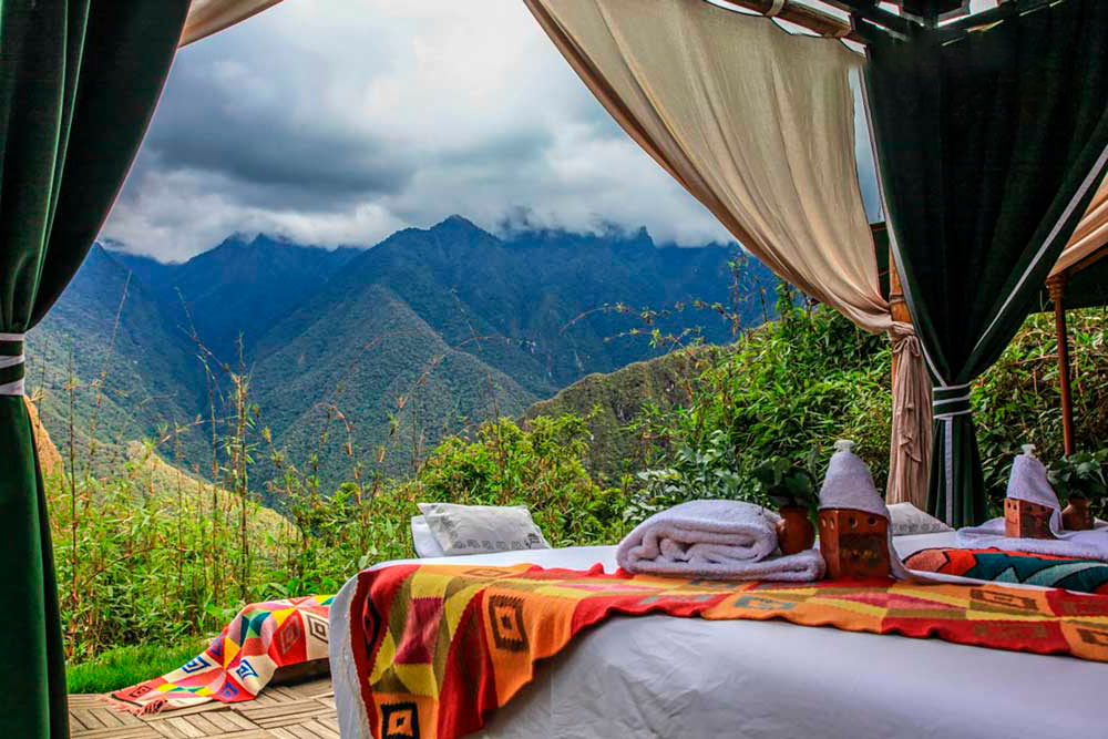 A breathtaking view of the Sacred Valley of the Incas, seen from a lavish luxury hotel suite, providing a serene and majestic experience │ Ile Tours